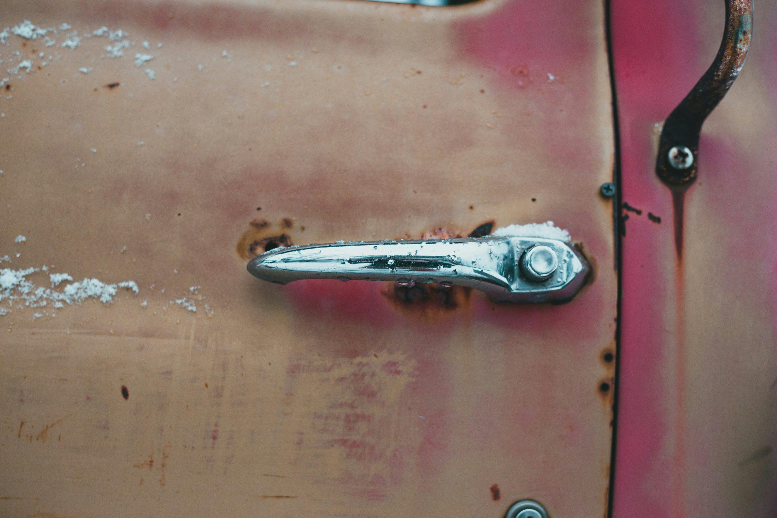 A close-up photo showing corroded metal zippers and salt stains on surfboard luggage.