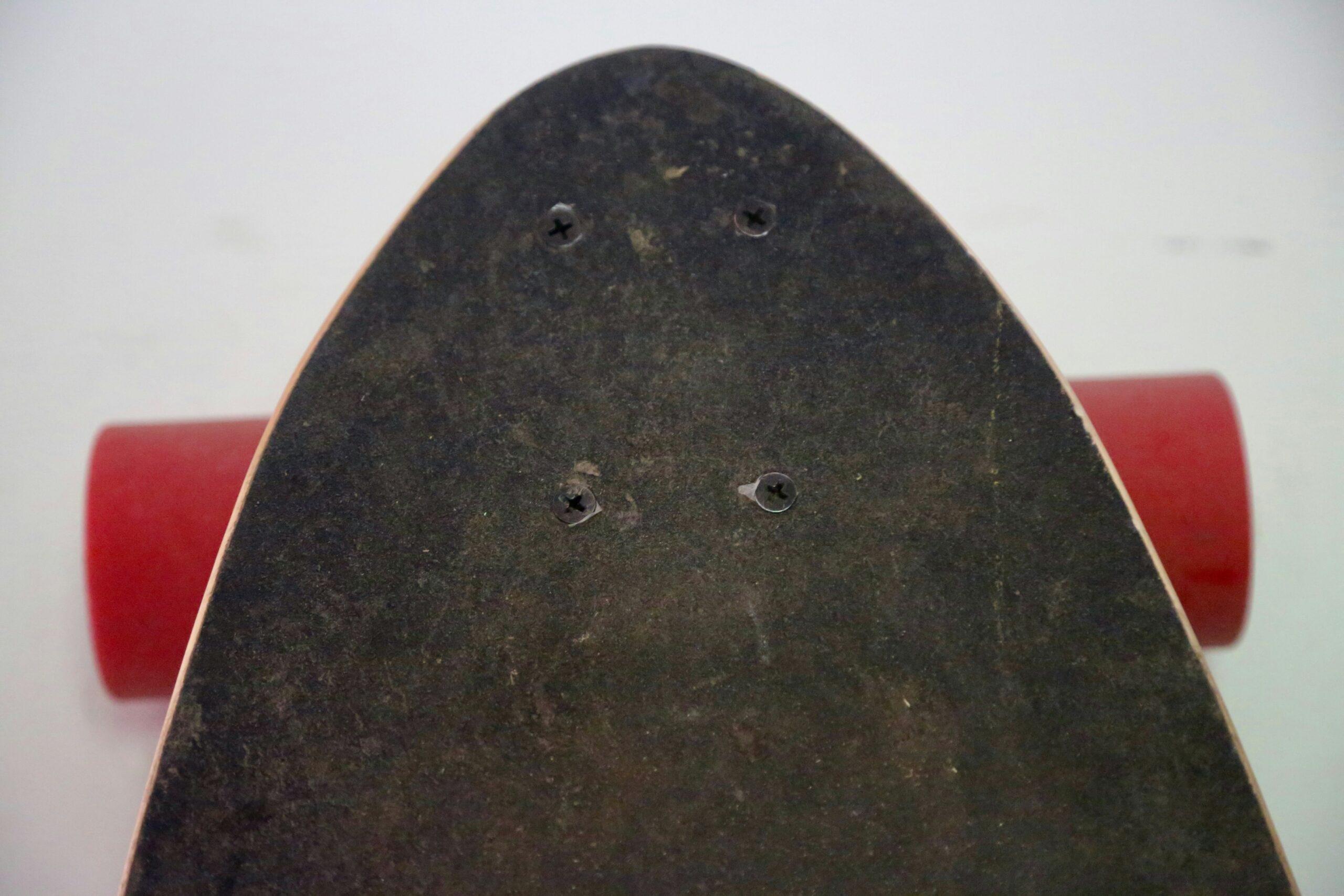 A cracked and discolored surfboard due to prolonged UV exposure.