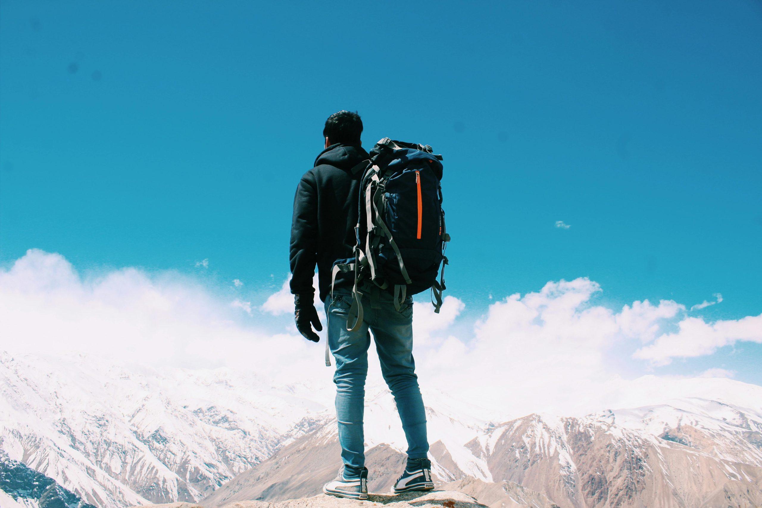 Smiling traveler holding a well-packed surfboard bag