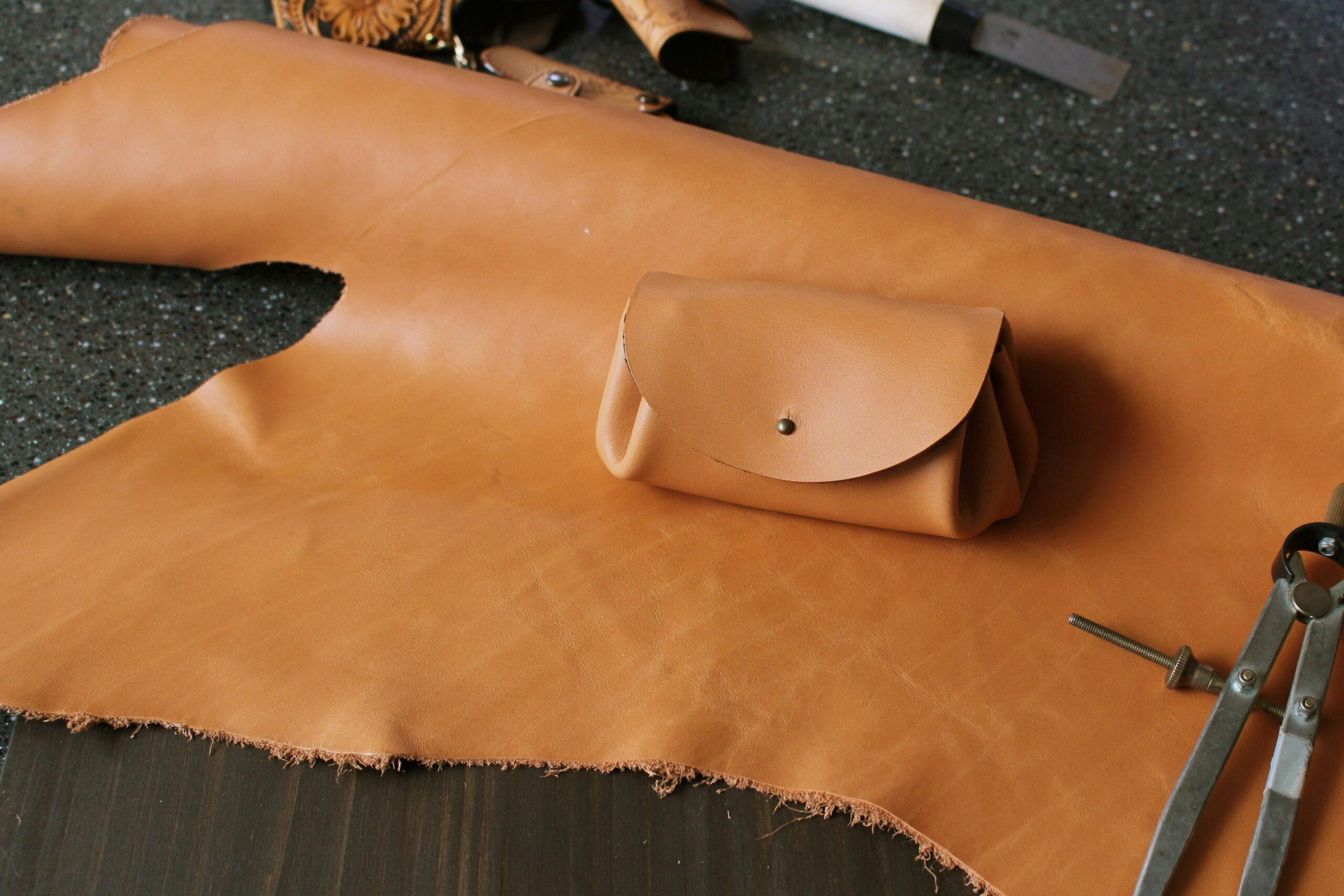 Someone applying a UV-resistant coating onto surfboard luggage with a foam brush.