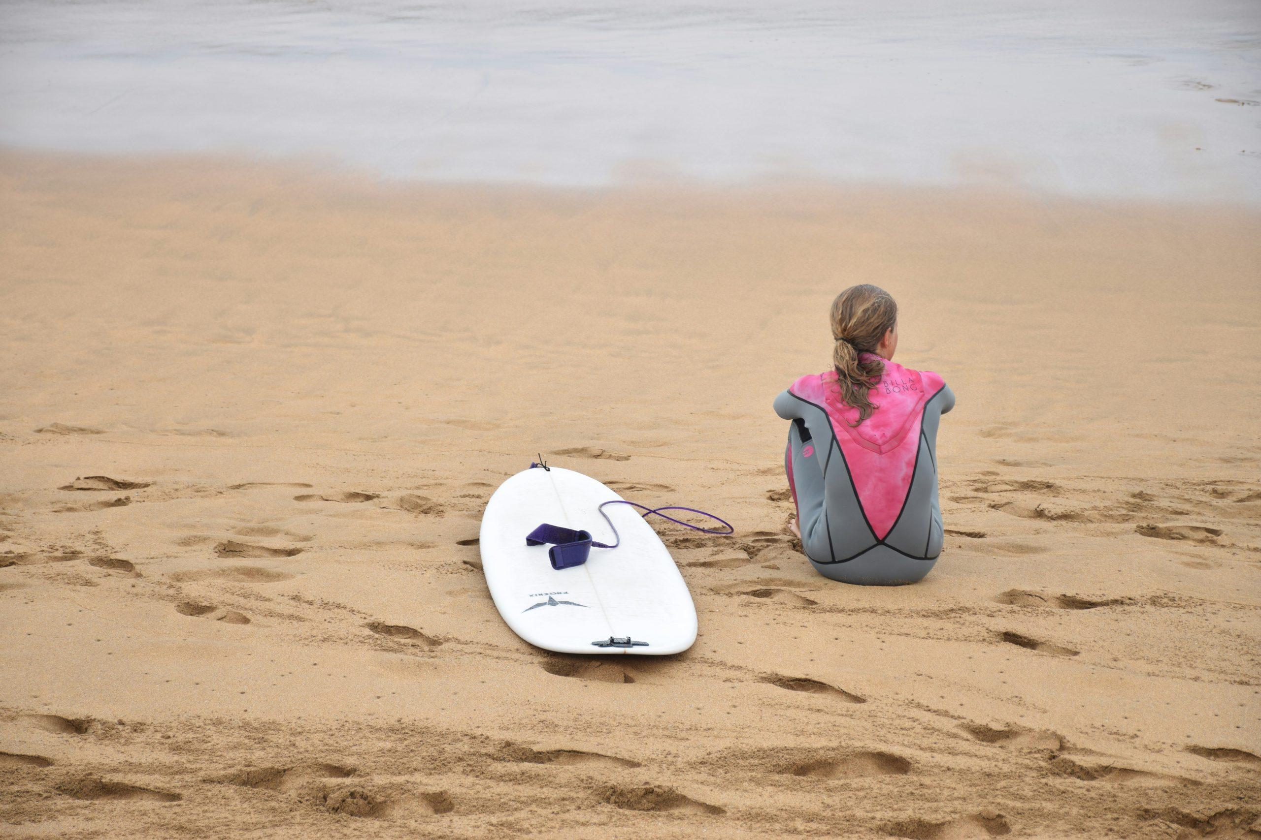 Surfer carefully inserting his board into a protective case