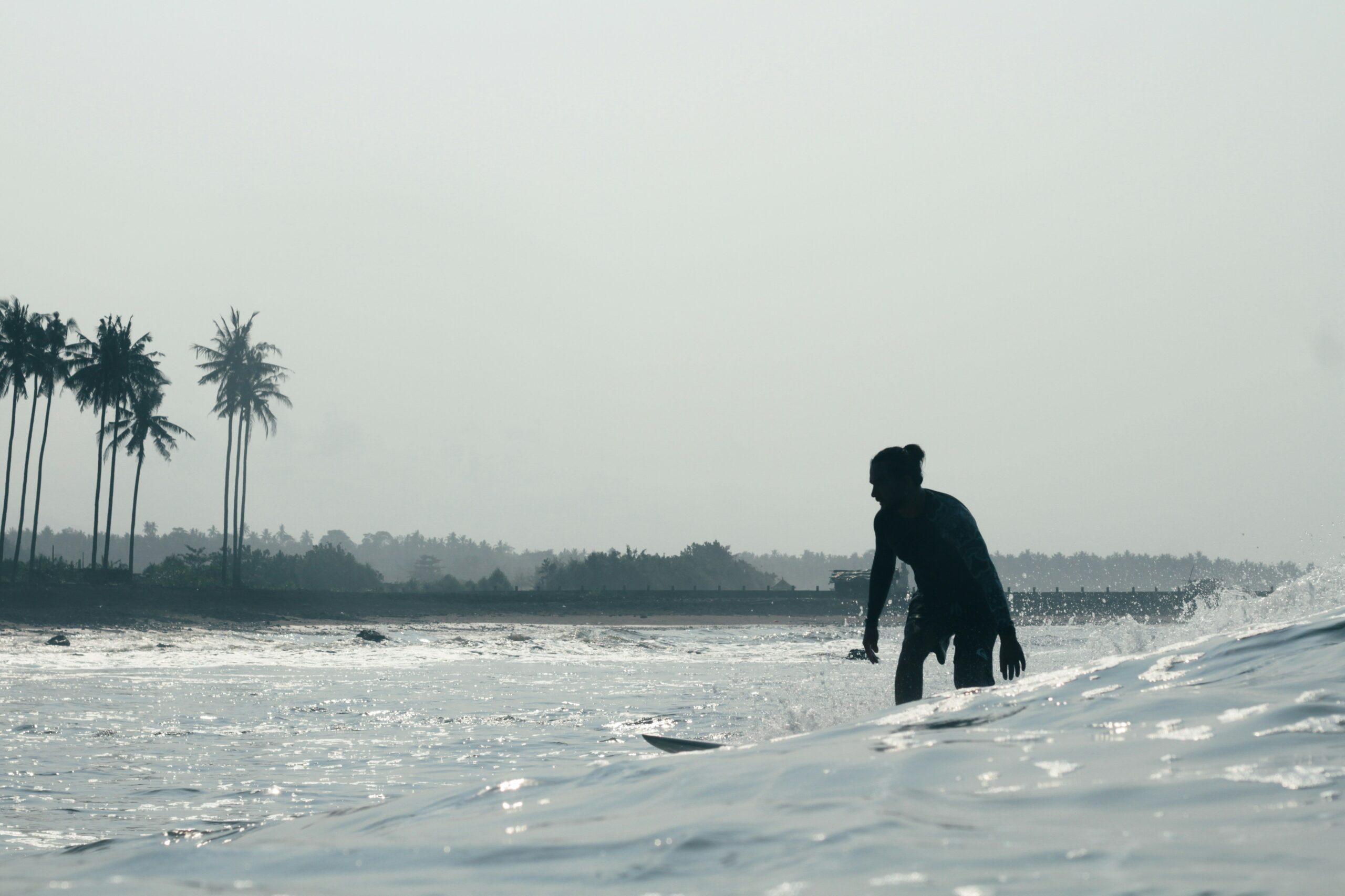 A photo showing plastic waste floating in the ocean near a beach