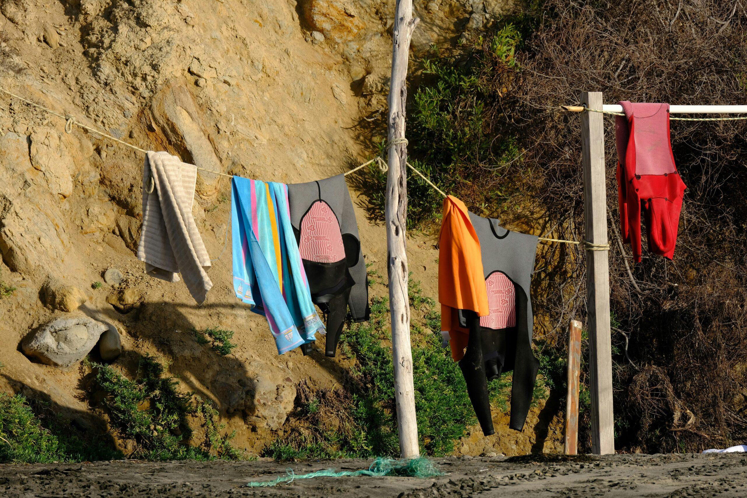 Surfer unpacking surfboard luggage near beach shoreline