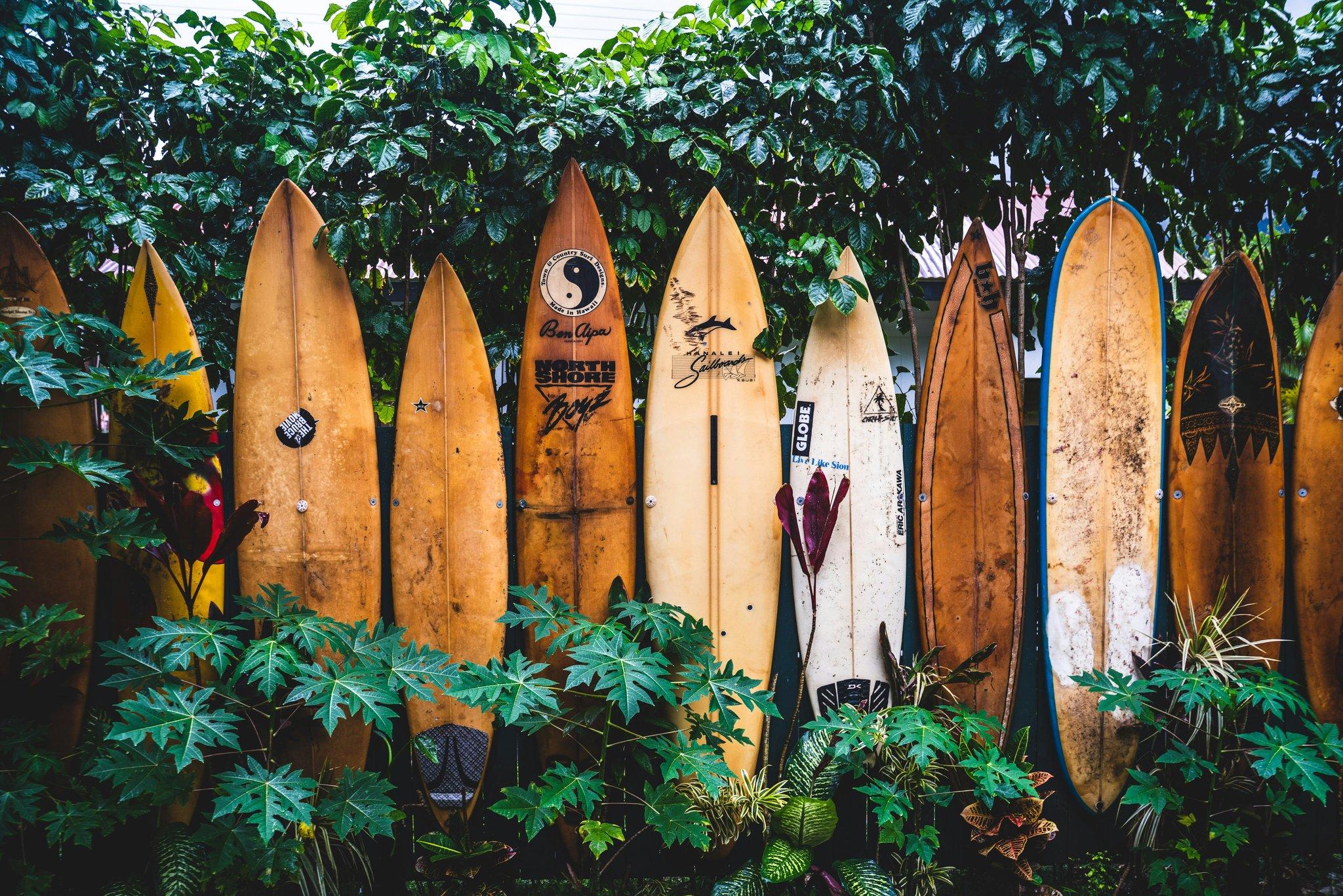 A cracked surfboard with duct-tape repairs