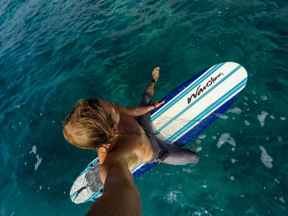 Closeup shot showing fins removed from a surfboard before placing it in a soft board vault bag.