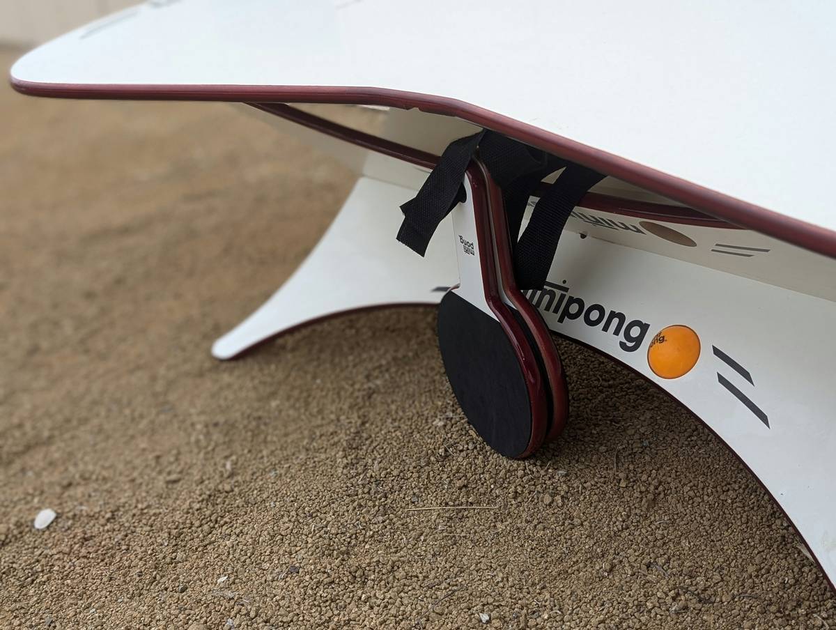 Happy surfer holding intact surfboard by ocean