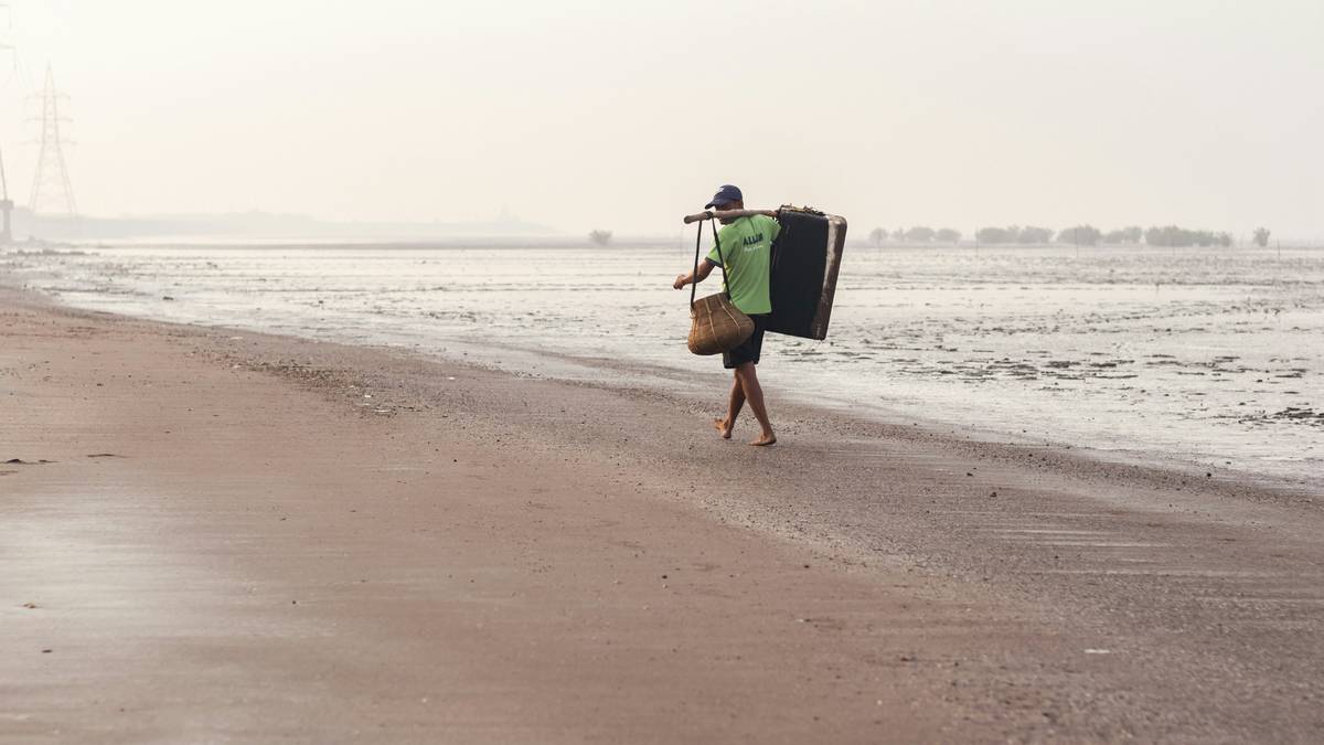 Happy surfer holding intact surfboard after long journey