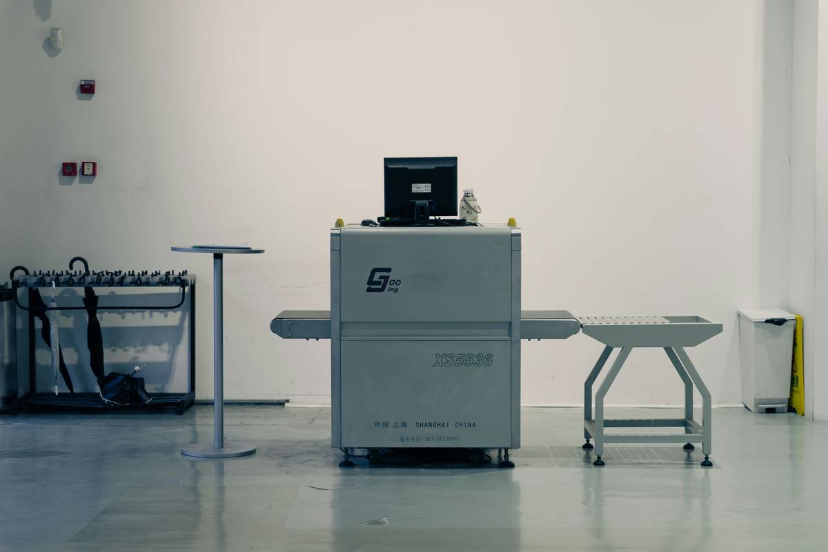 A damaged surfboard next to tools used for fixing it