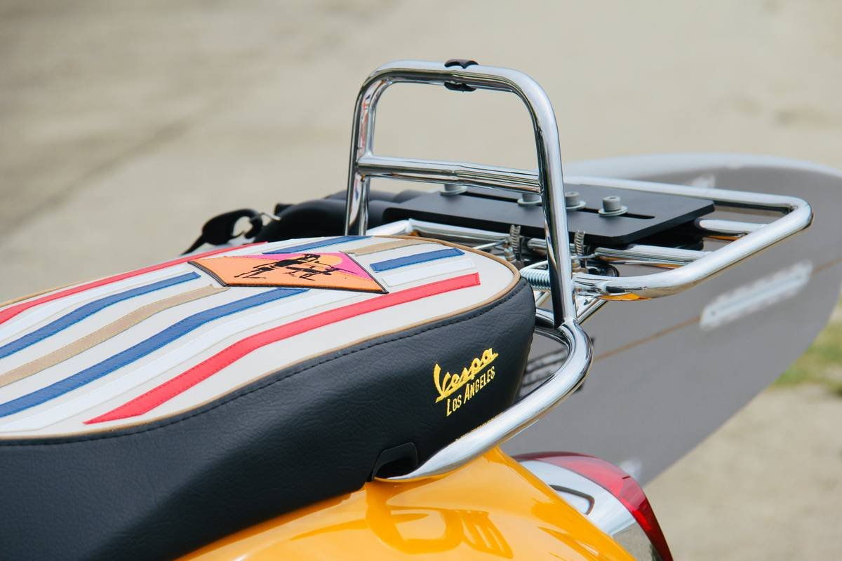 A surfer packing their surfboard into a high-quality, durable surfboard luggage bag.