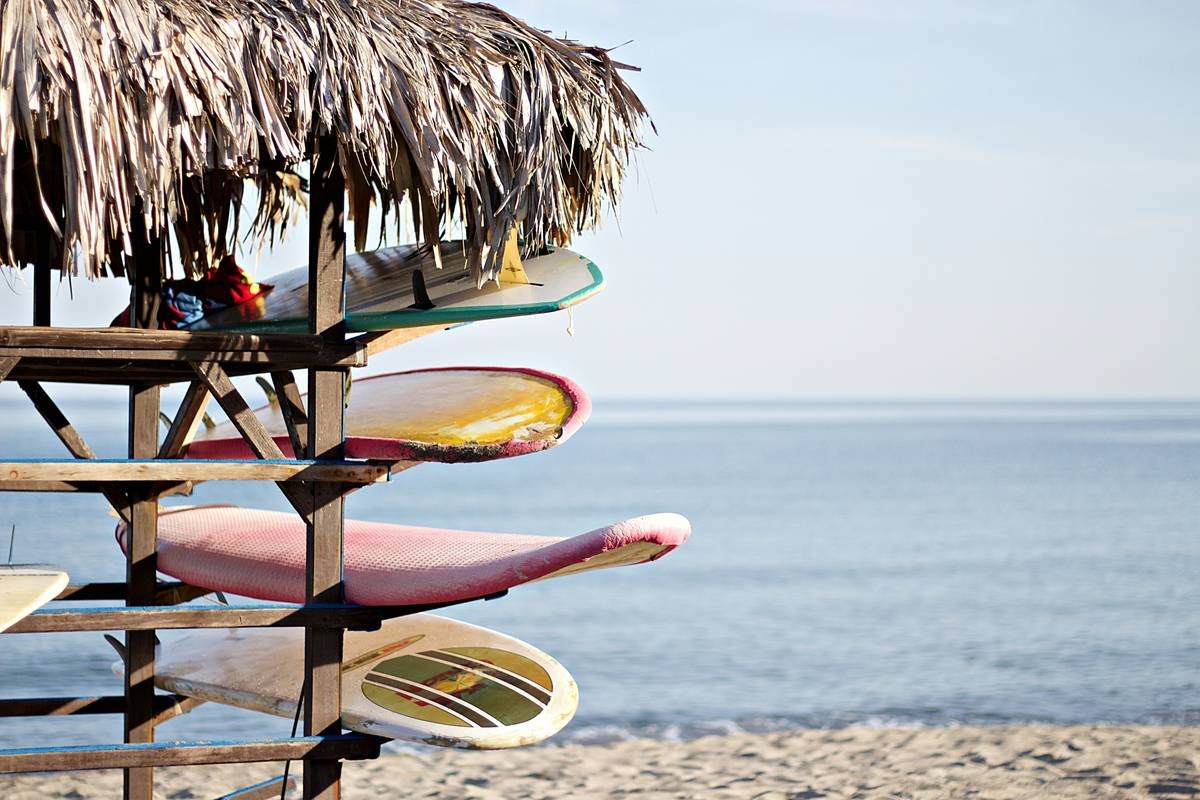 Wave shield surfboard is permanent in travel setup with hard-shell case on tarmac