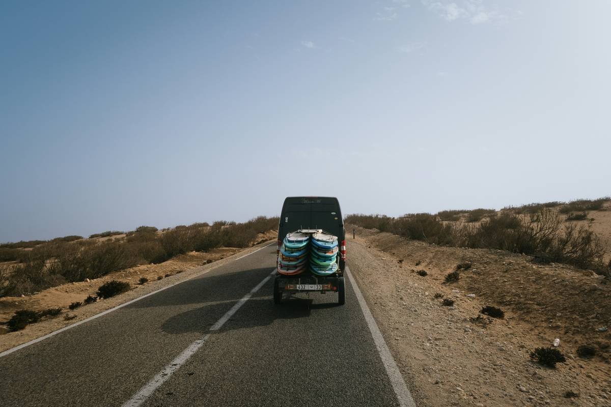 surfer carefully packing surfboard for surf transport surfboard how to pack using pool noodles and foam padding